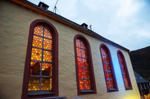 Evangelische Kirche in Wolf Die Kirchenfenster der Evangelischen Kirche strahlen rot-gelb von innen